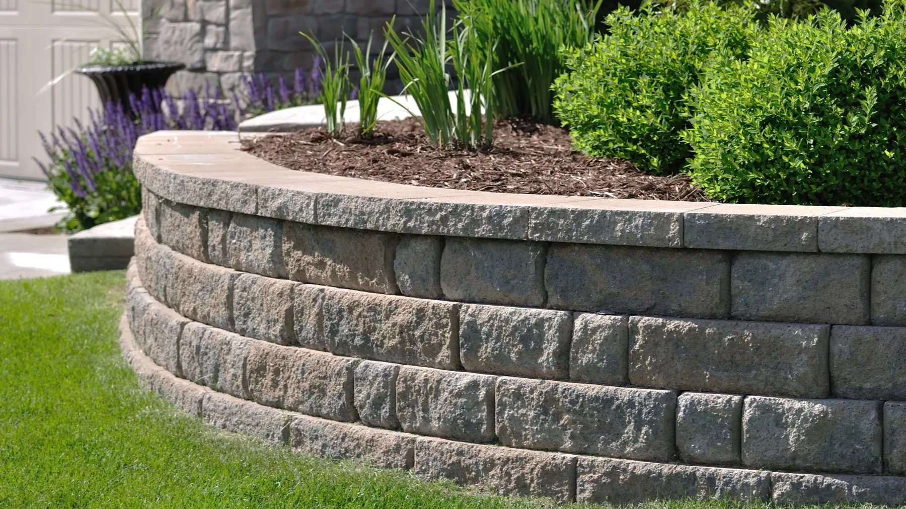 Armour stone retaining walls framing a landscaped Guelph property